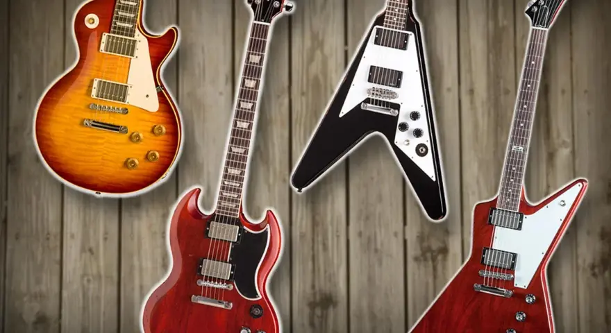 Vier Gibson E-Gitarren: Les Paul, SG, Flying V und Explorer auf Holz Hintergrund.
